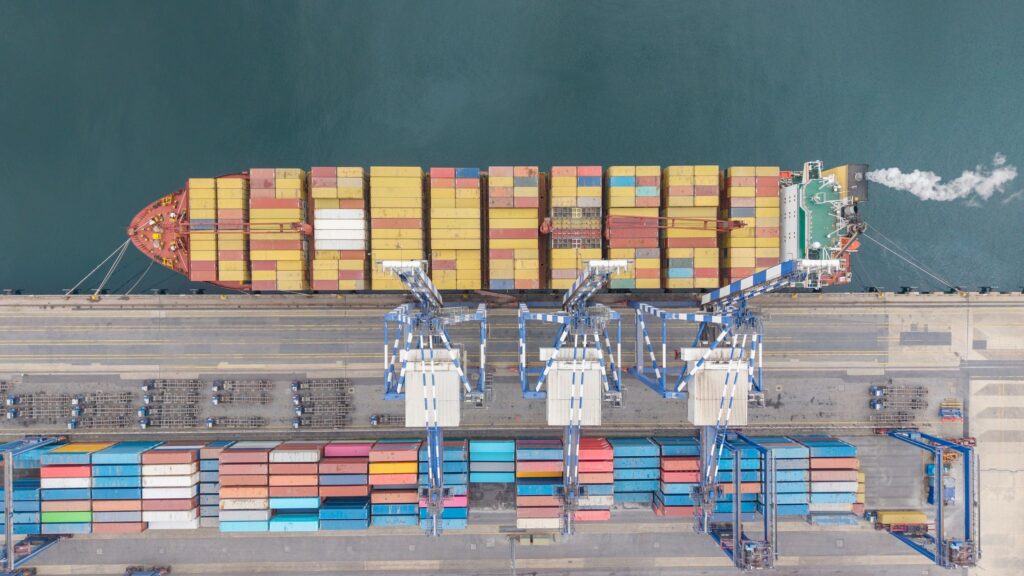 Container ship at port loading cargo aerial view